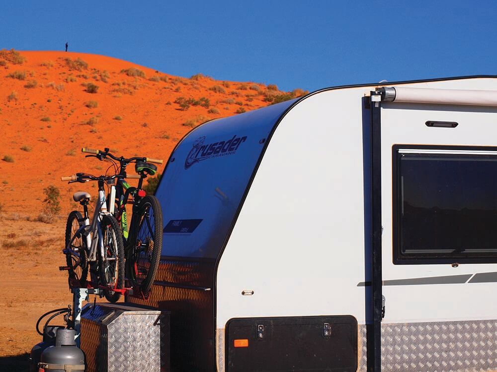 A Caravan With Two Bikes Attached To The Side Of It — Lake Macquarie Caravan Repairs In Cardiff, NSW