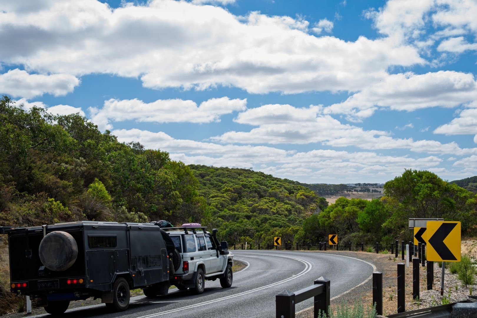 Vehicle Towing Trailer on Winding Road — Lake Macquarie Caravan Repairs In Cardiff, NSW