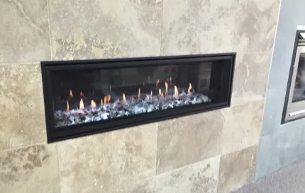 a fireplace is built into a tiled wall in a living room .
