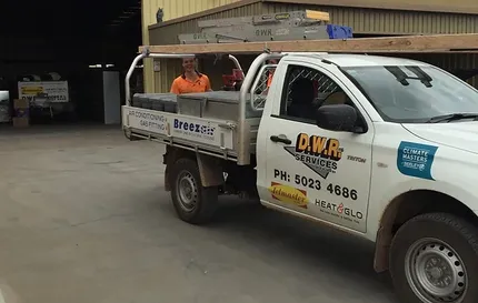 ute with DWR Services branding on the side in front of a shed