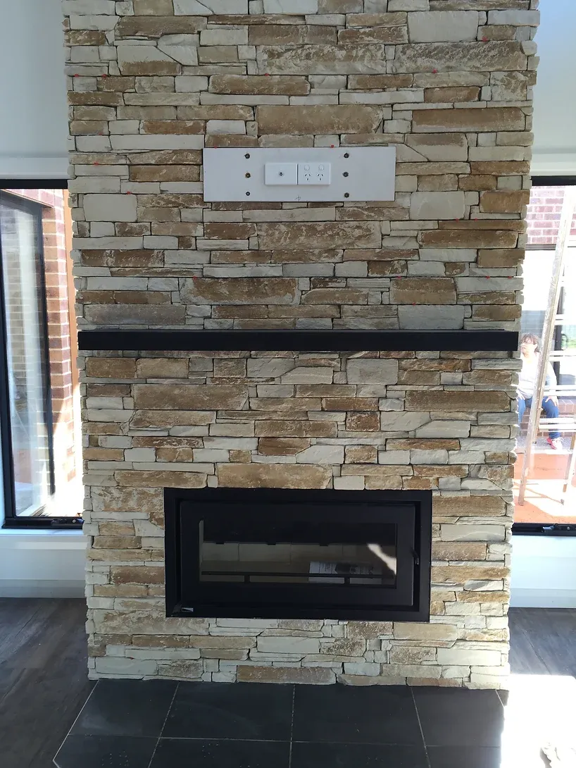 fireplace installed by dwr services built into floor to ceiling stone mantle piece 