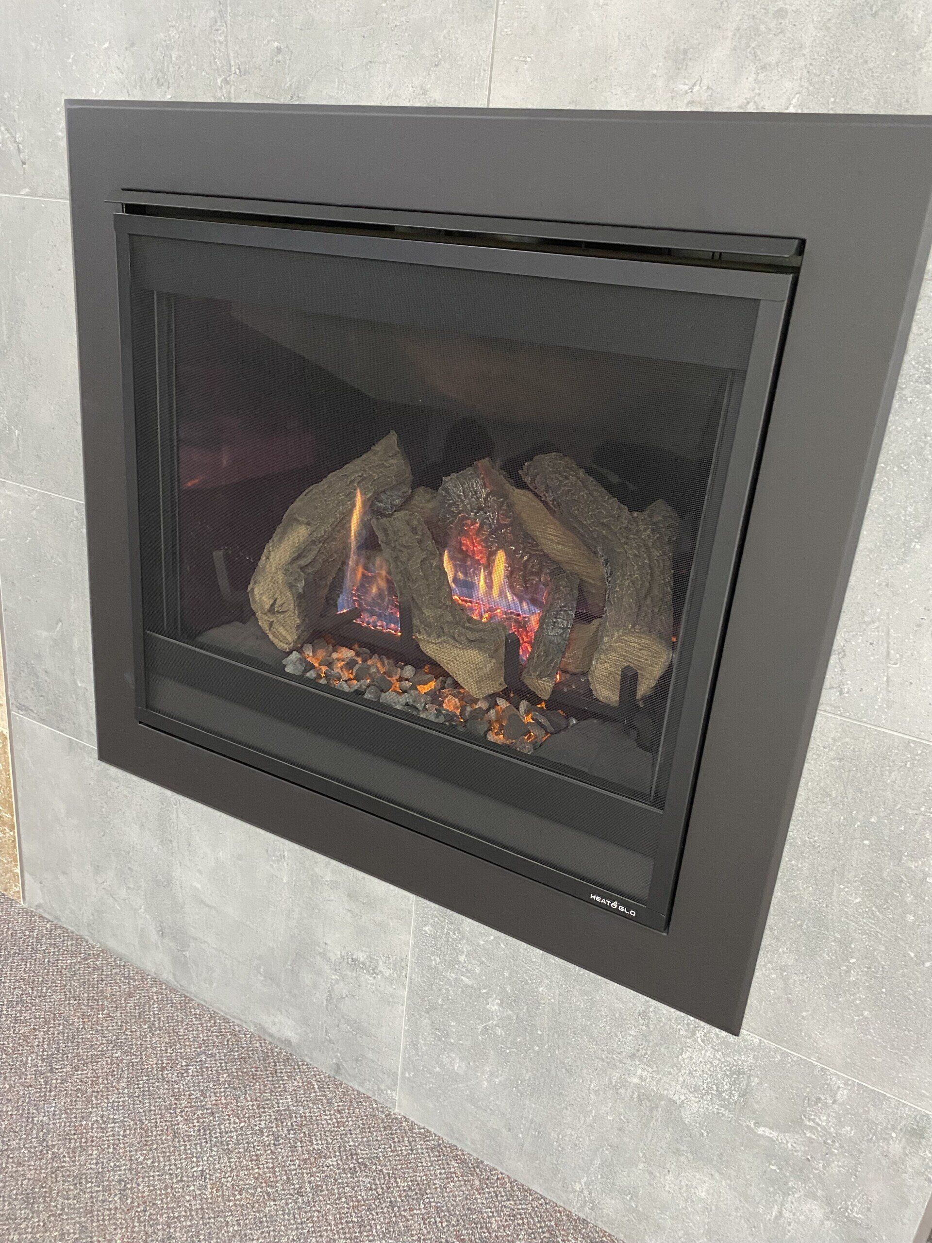 heat glo square fireplace built into tiled wall 