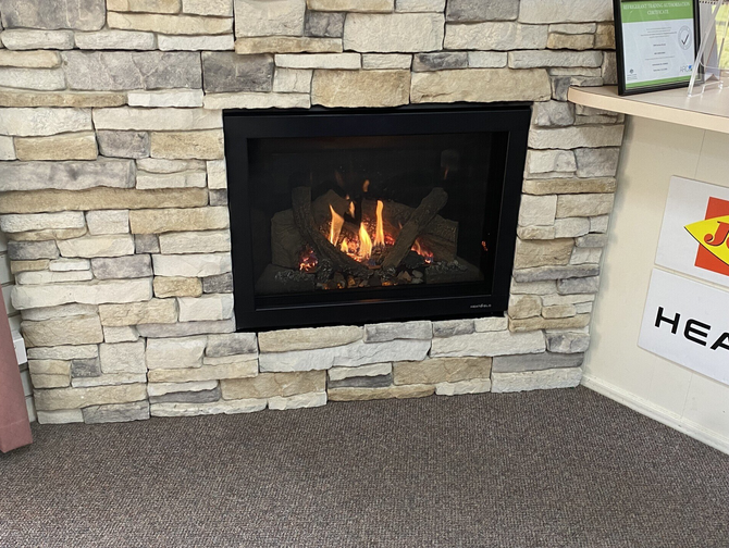 a fireplace is built into a stone wall in a display room