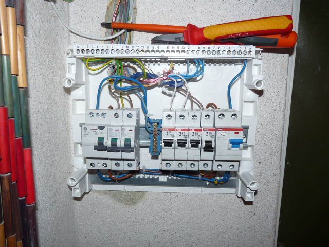 A screwdriver is sitting on top of an electrical box