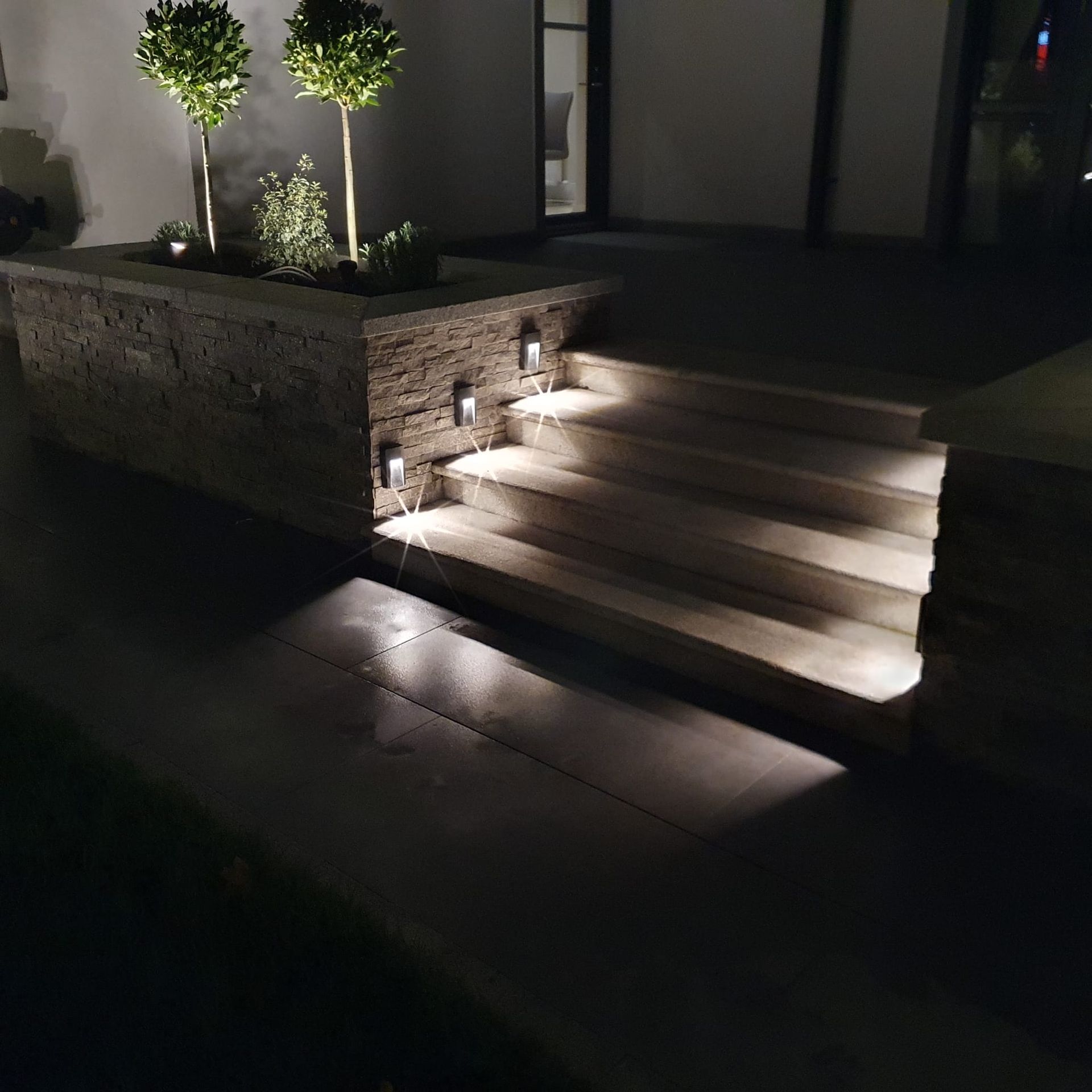A set of stairs leading up to a house at night