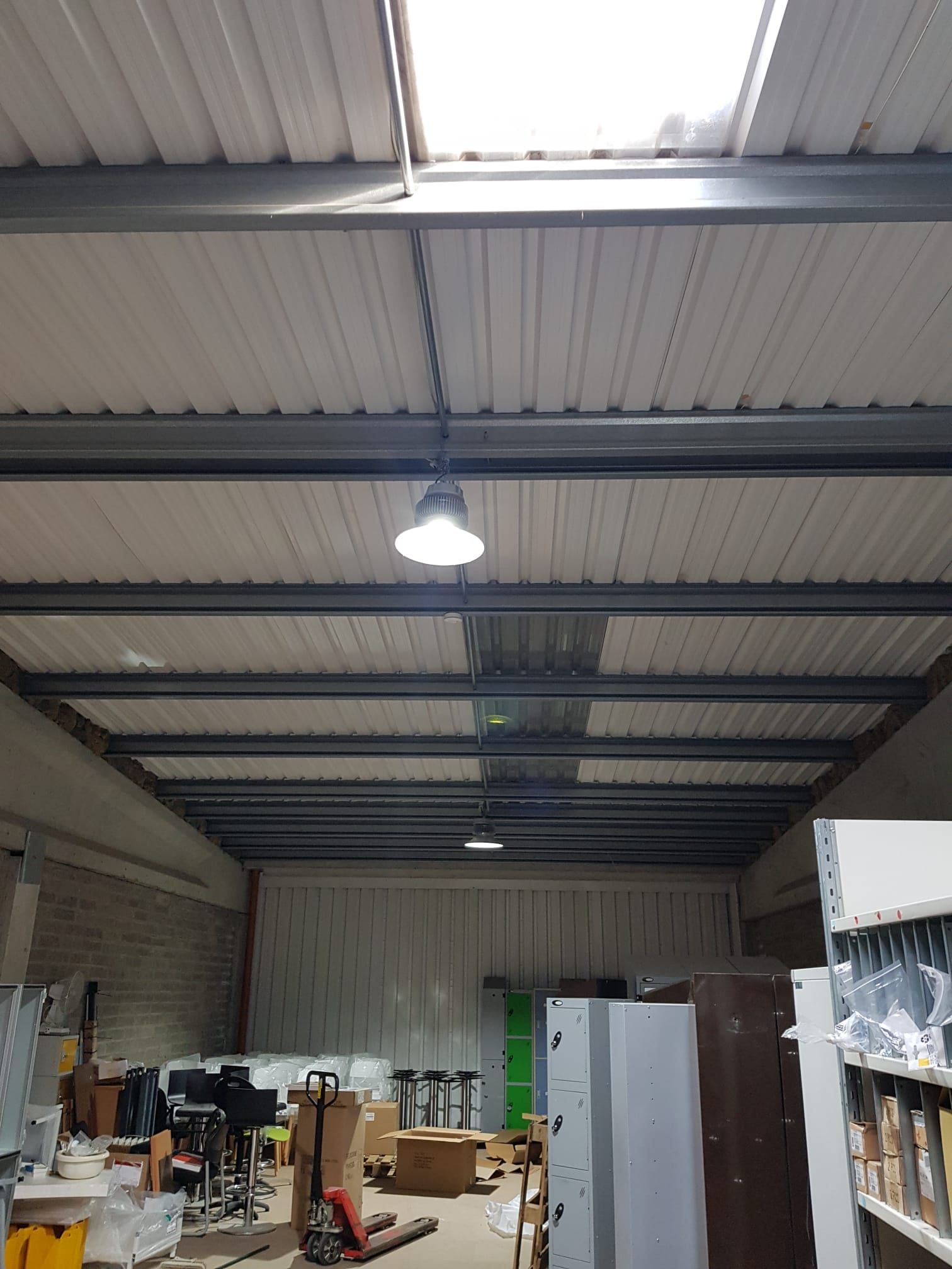 A large warehouse with a skylight in the ceiling.