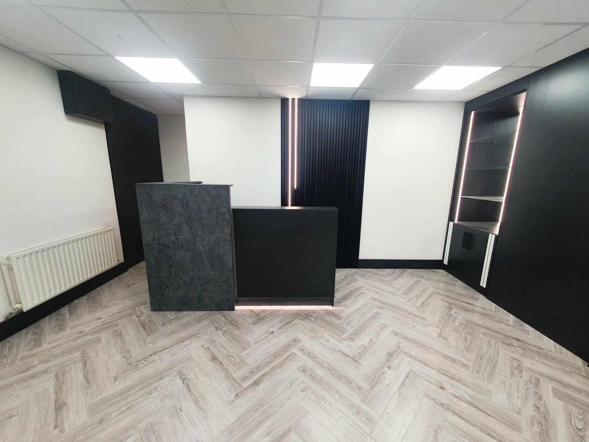There is a black counter in the middle of the room.