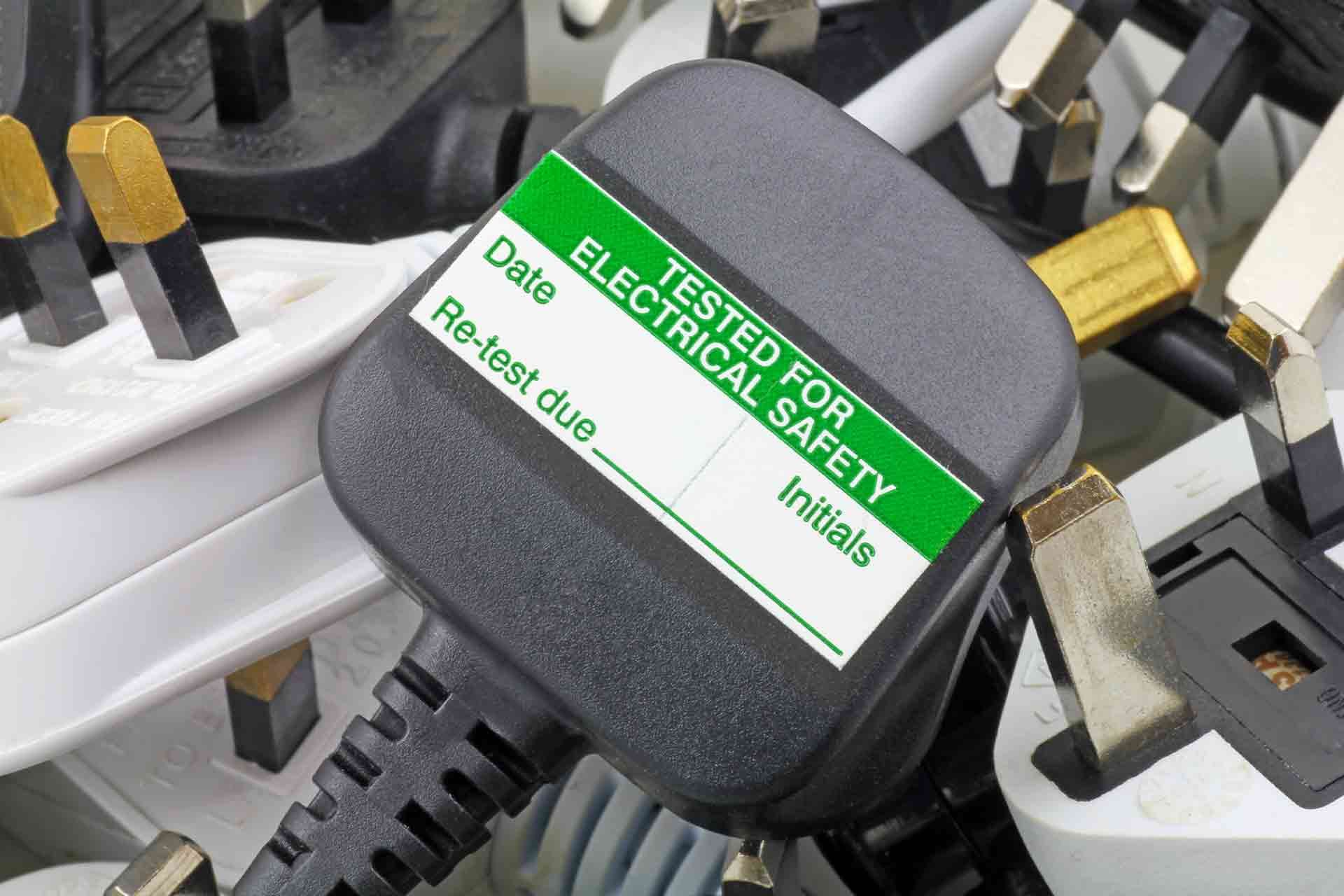 A close up of a tested for electrical safety plug