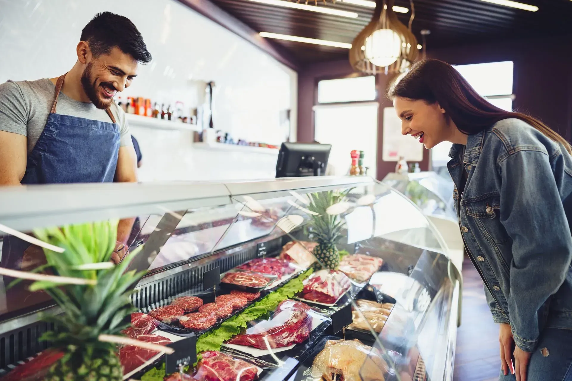 Woman looking at meat in the butcher shop
