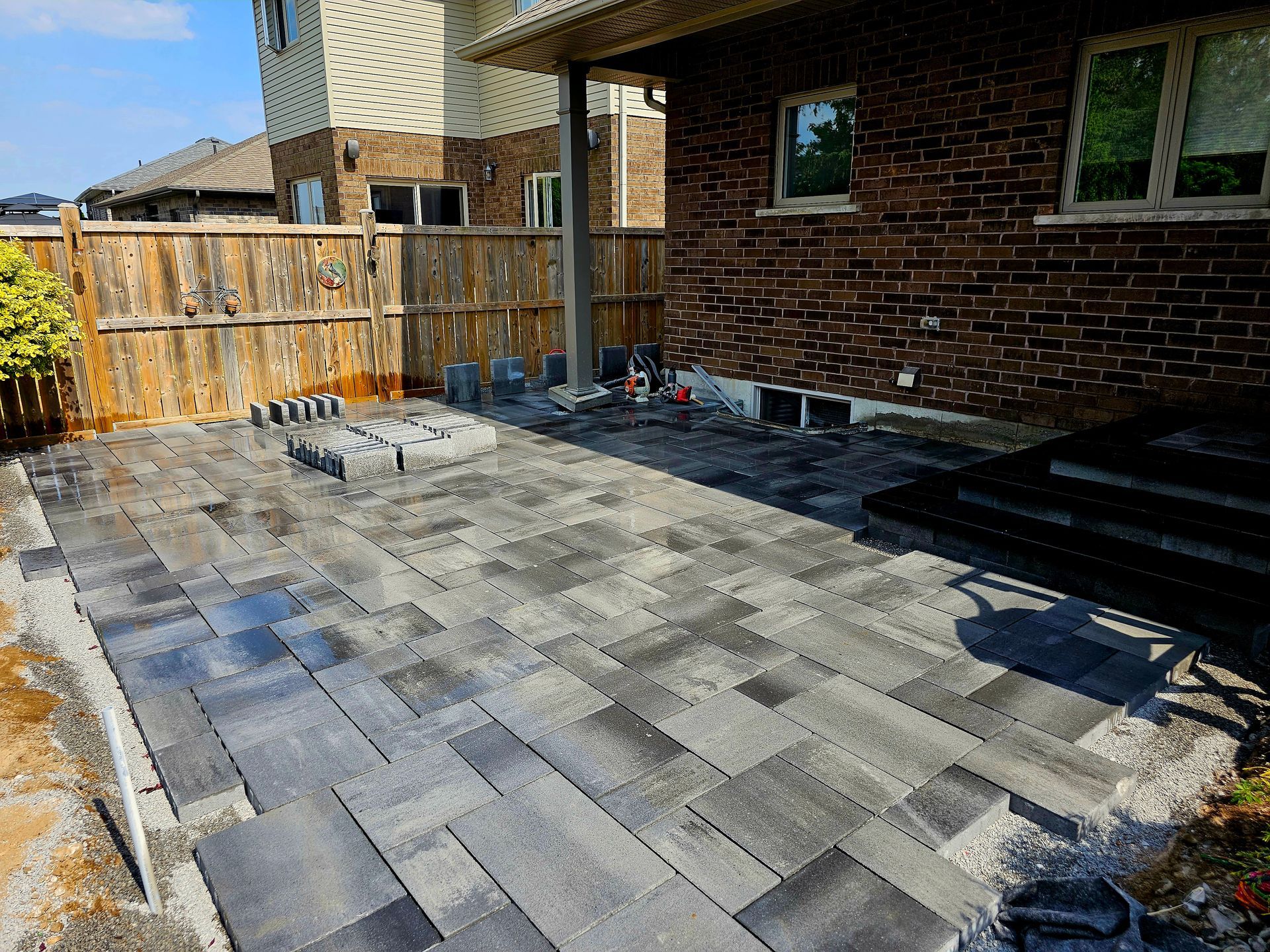 a brick house with a patio being built in front of it .