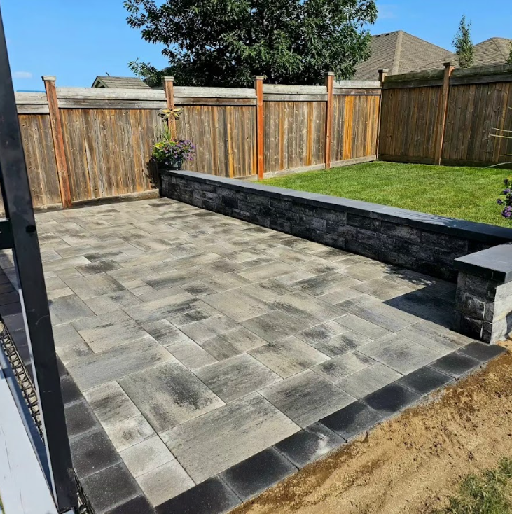 a patio with a wooden fence in the background