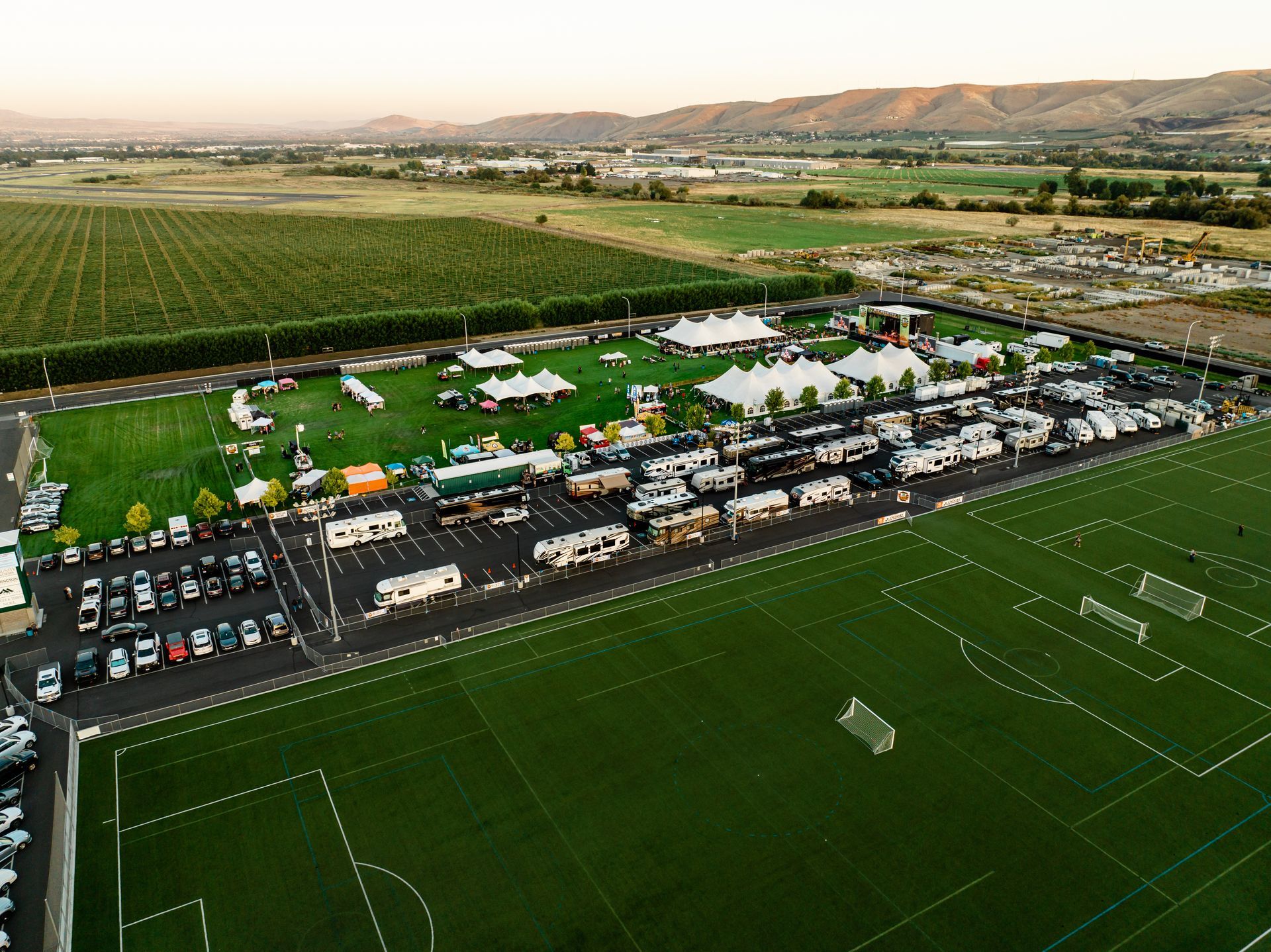 An aerial view of a soccer field and a parking lot.