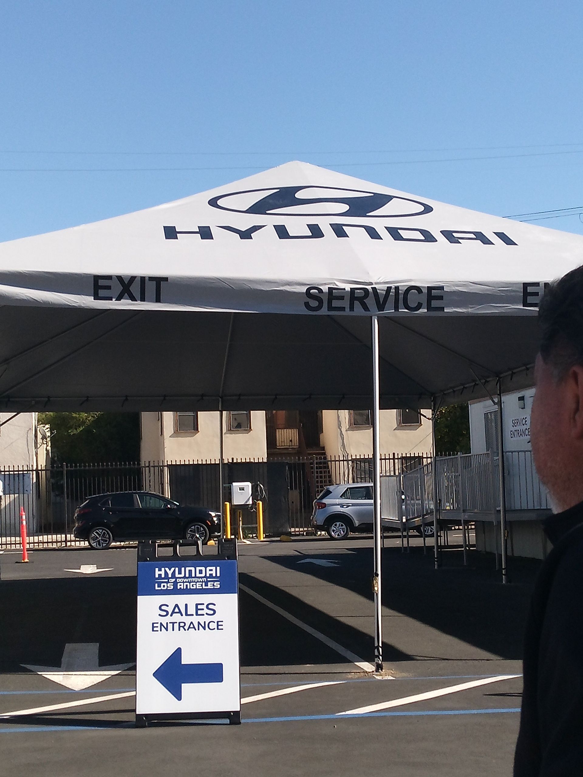 Hyundai sales tent with EXIT and SERVICE signs, plus a “SALES” arrow sign in front