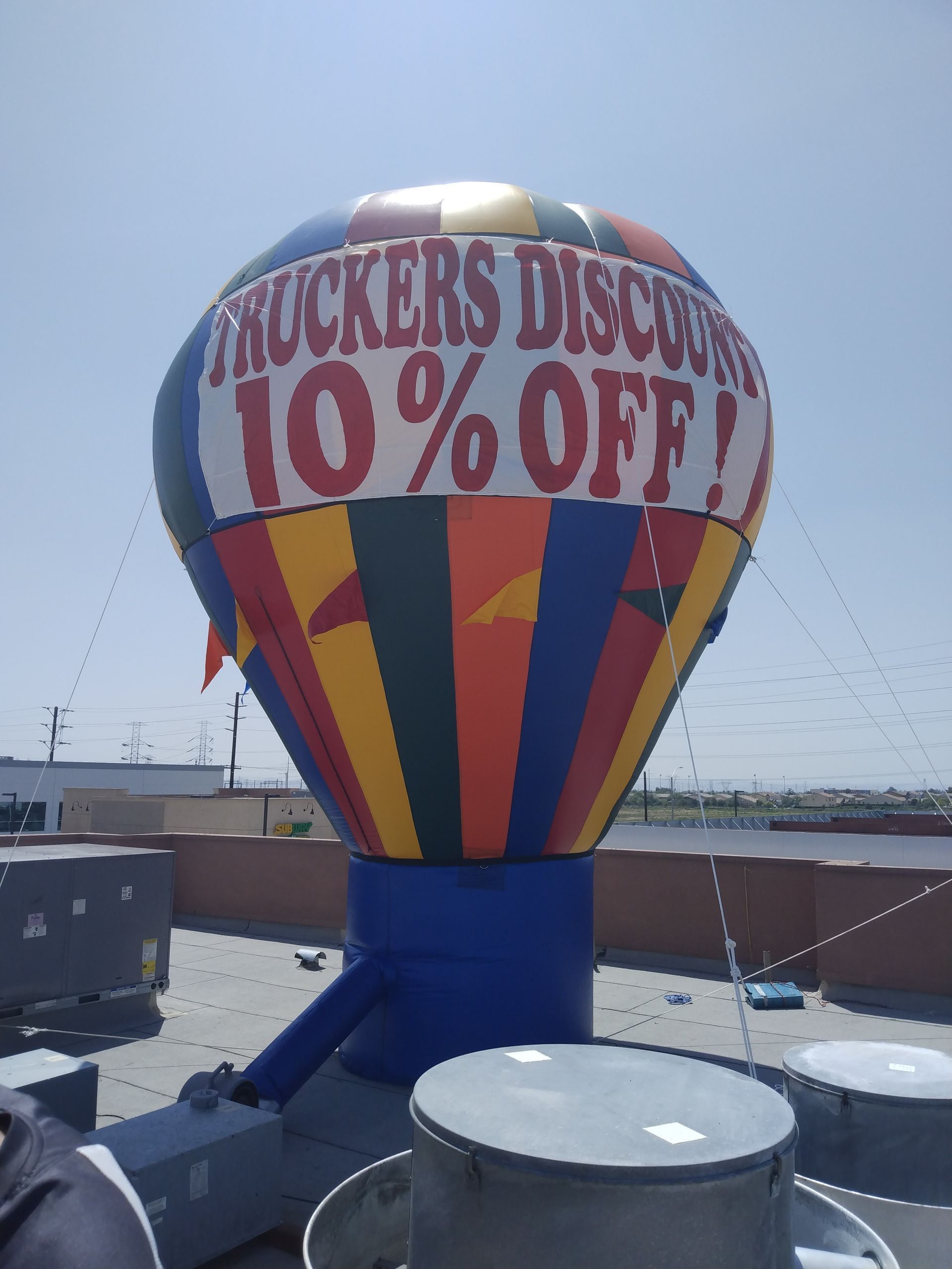 Tukker's Discount hot air balloon display with “10% OFF!” text in bright colors outdoors