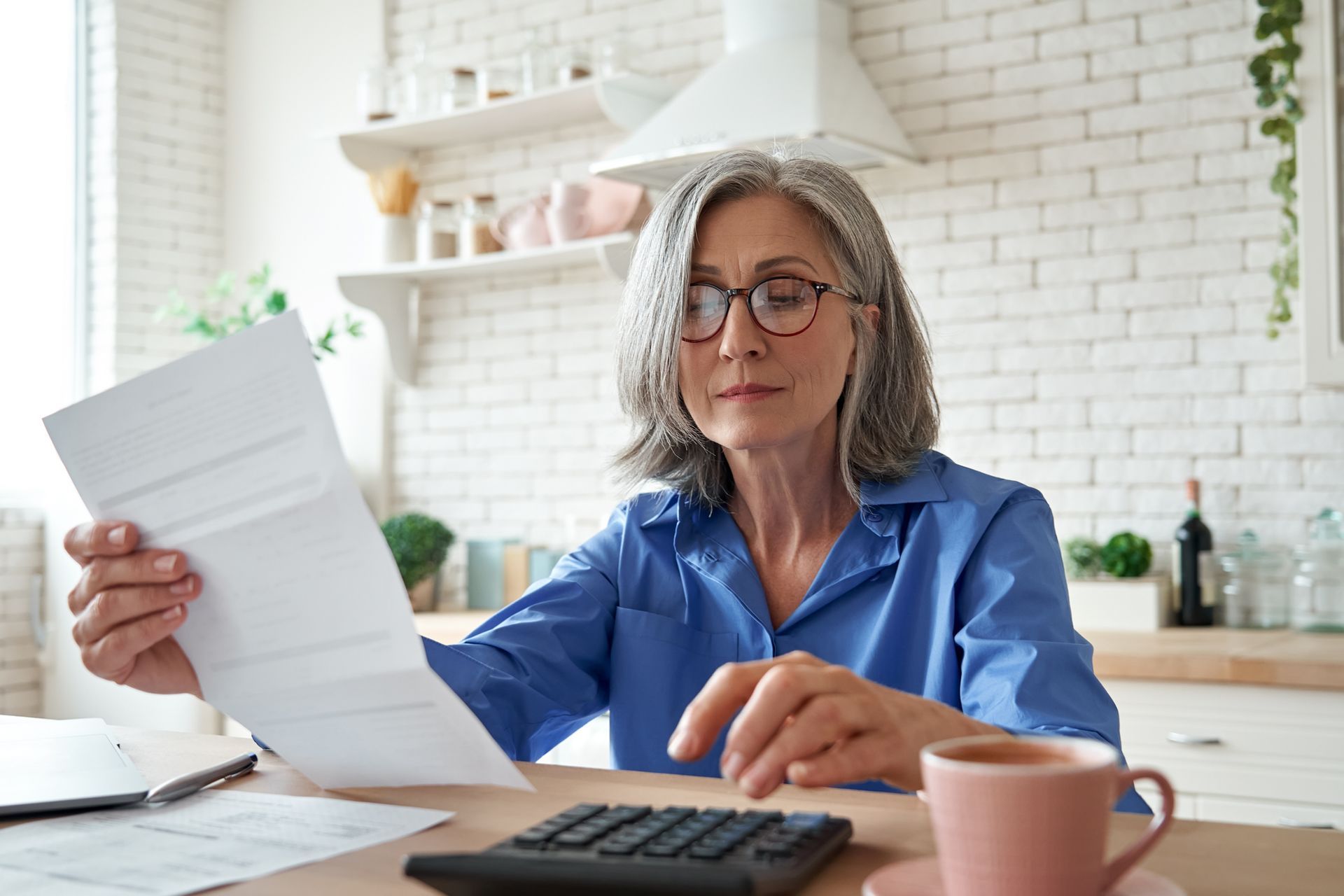 Senior Woman Holding a Paper — Campbelltown, NSW — Gorman Jones Lawyers
