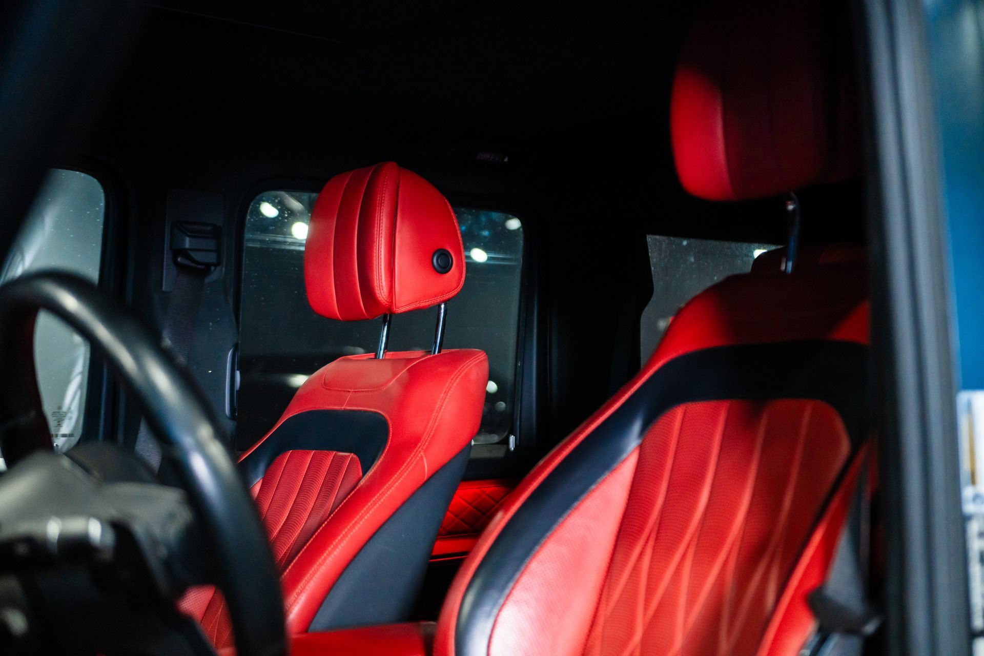 Red leather car seats with black trim inside a vehicle interior
