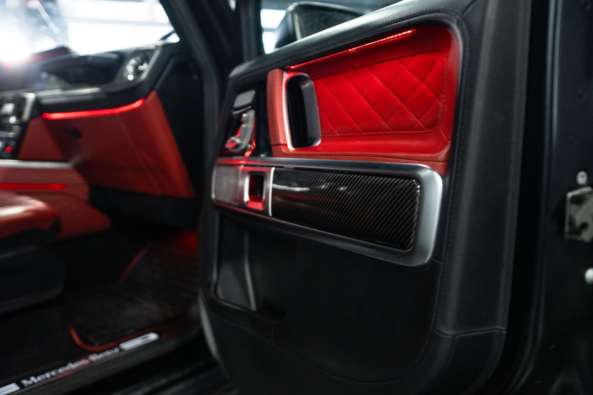 Red leather car interior with quilted door panels and carbon-fiber trim