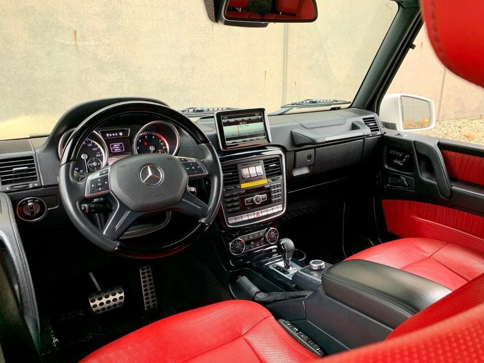 Mercedes-Benz car interior with red leather seats, steering wheel, dashboard, and center console