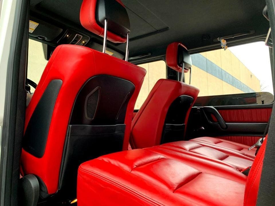 Red and black car interior with sporty seats and quilted red leather bench seat.