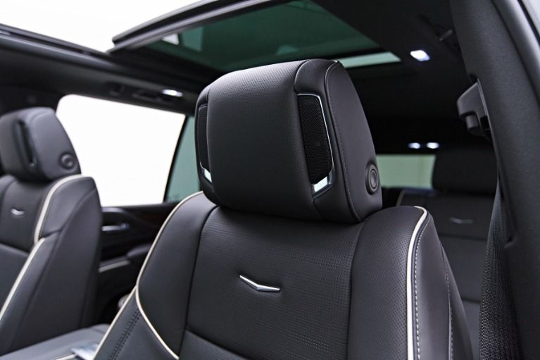 Black leather car seats in a luxury SUV with a panoramic glass roof￼