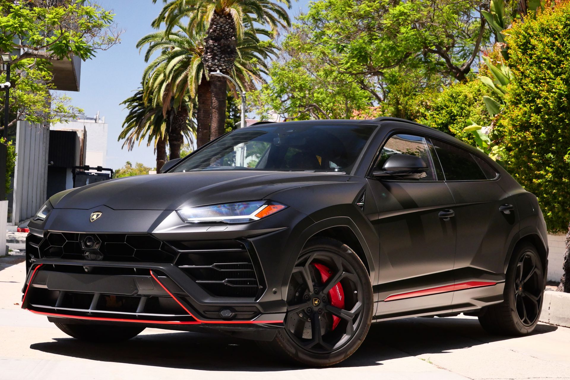Black Lamborghini Urus SUV parked outdoors with red accents.