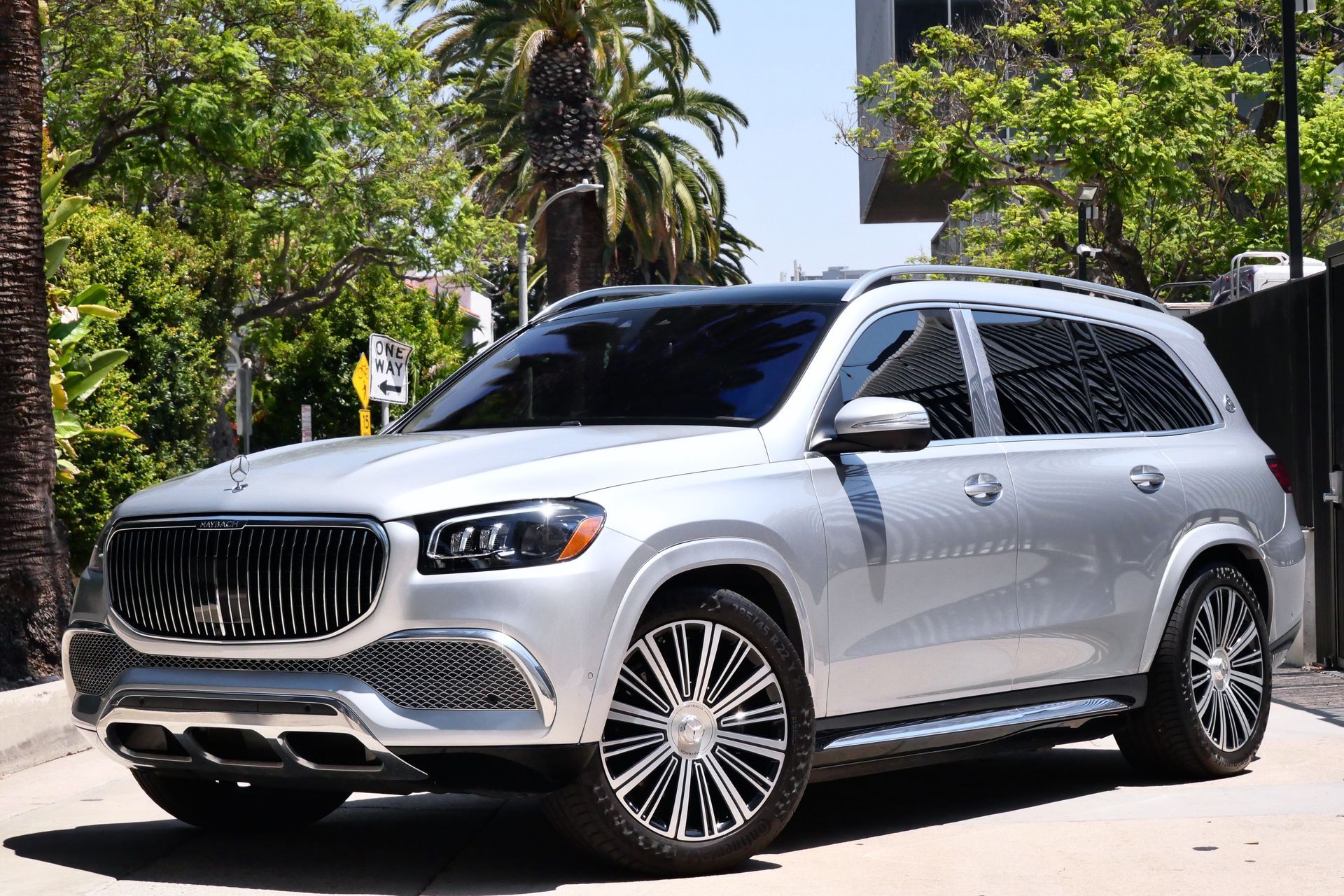 Silver Mercedes-Maybach GLS SUV parked on a city street, sunny day.
