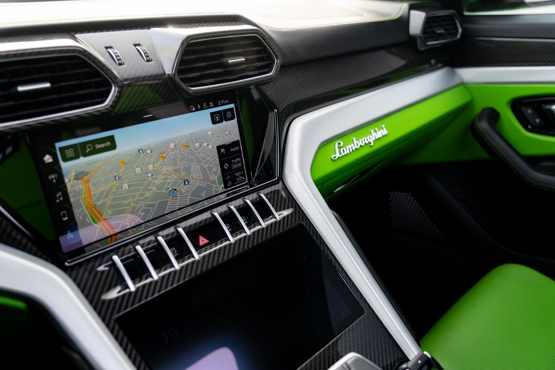 Luxury car interior with bright green trim, dashboard screen, and center air vents