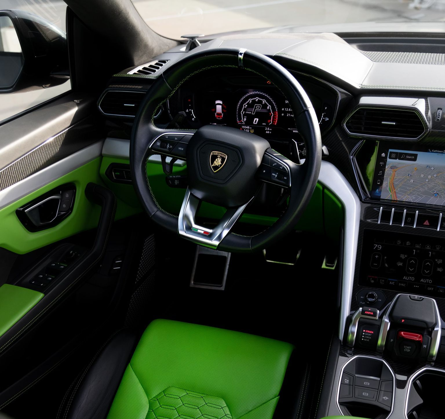 Luxury sports car interior with black and bright green accents, steering wheel, and dashboard
