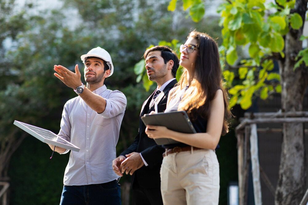 A Group Of People Are Standing Next To Each Other In A Park — Keystone Engineering Sheet Metal Industries in Noosaville, QLD