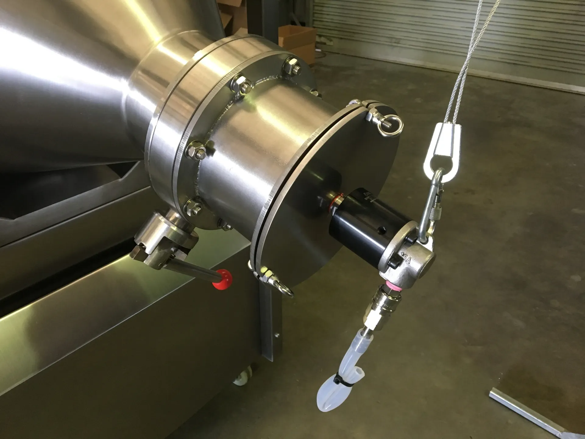 A close up of a stainless steel pipe with a chain attached to it — Keystone Engineering Sheet Metal Industries in Noosaville, QLD