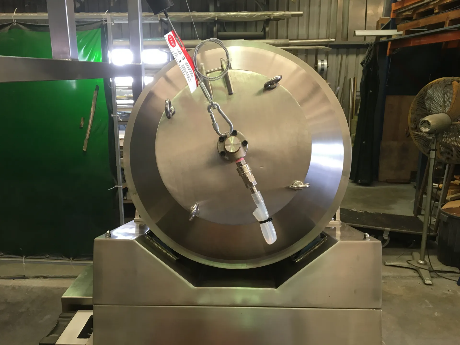 A large stainless steel machine is sitting in a warehouse. — Keystone Engineering Sheet Metal Industries in Noosaville, QLD