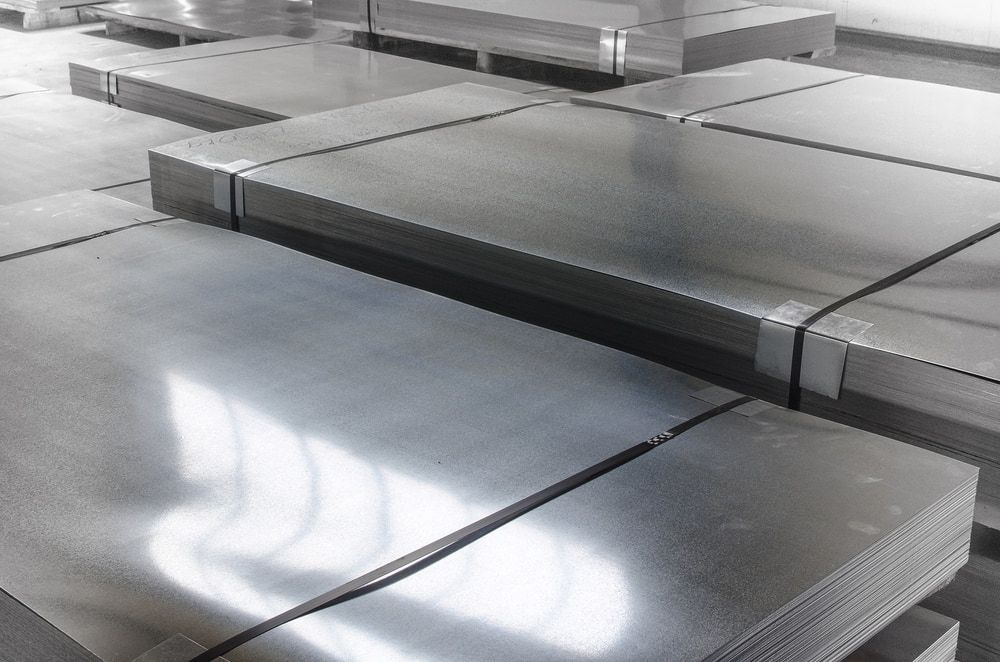 A Bunch Of Metal Sheets Are Stacked  In A Warehouse — Keystone Engineering Sheet Metal Industries in Noosaville, QLD