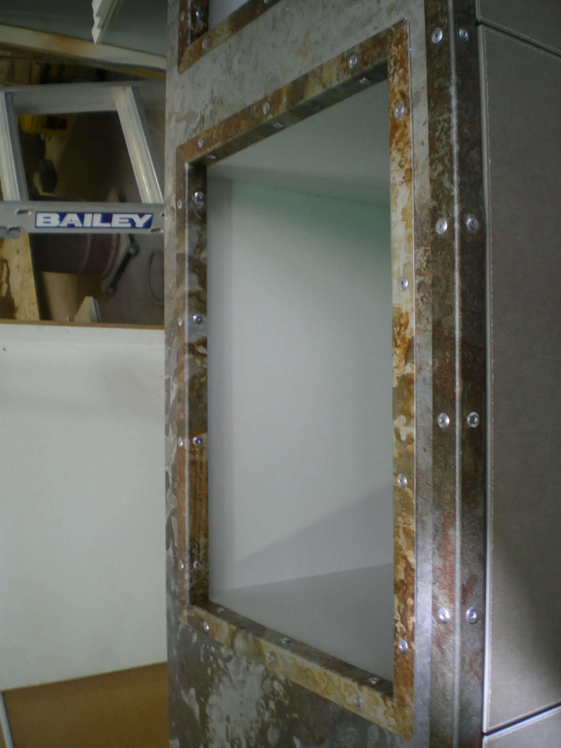 A bailey sign is on a wall next to a window — Keystone Engineering Sheet Metal Industries in Noosaville, QLD