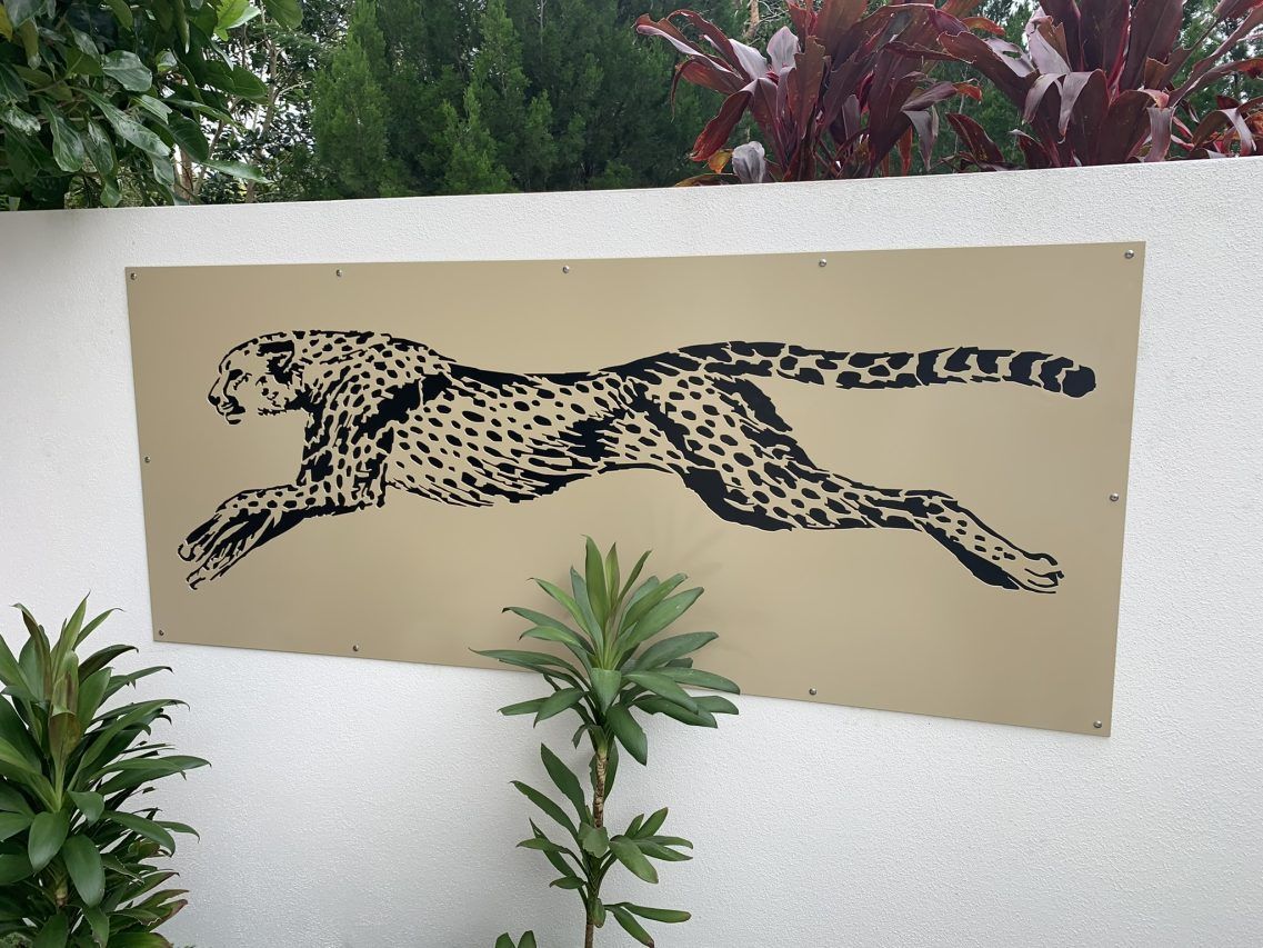 A painting of a cheetah on a white wall — Keystone Engineering Sheet Metal Industries in Noosaville, QLD