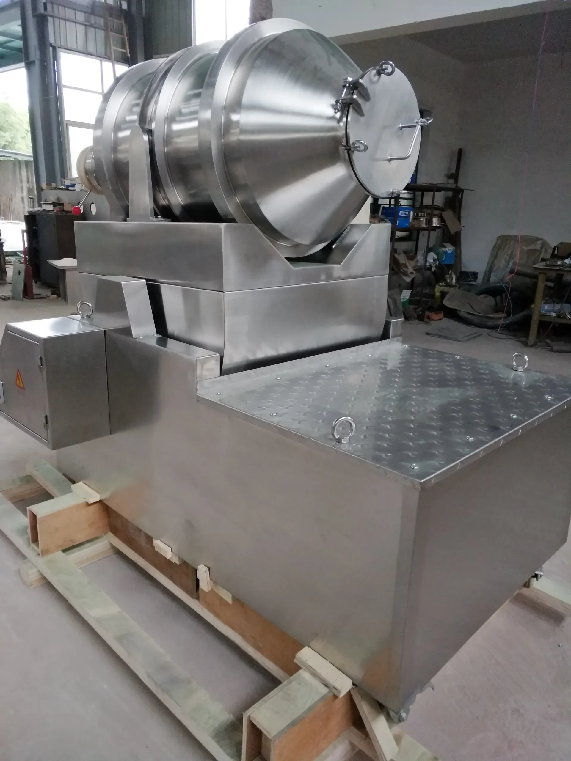 A large stainless steel machine is sitting on top of a wooden pallet. — Keystone Engineering Sheet Metal Industries in Noosaville, QLD