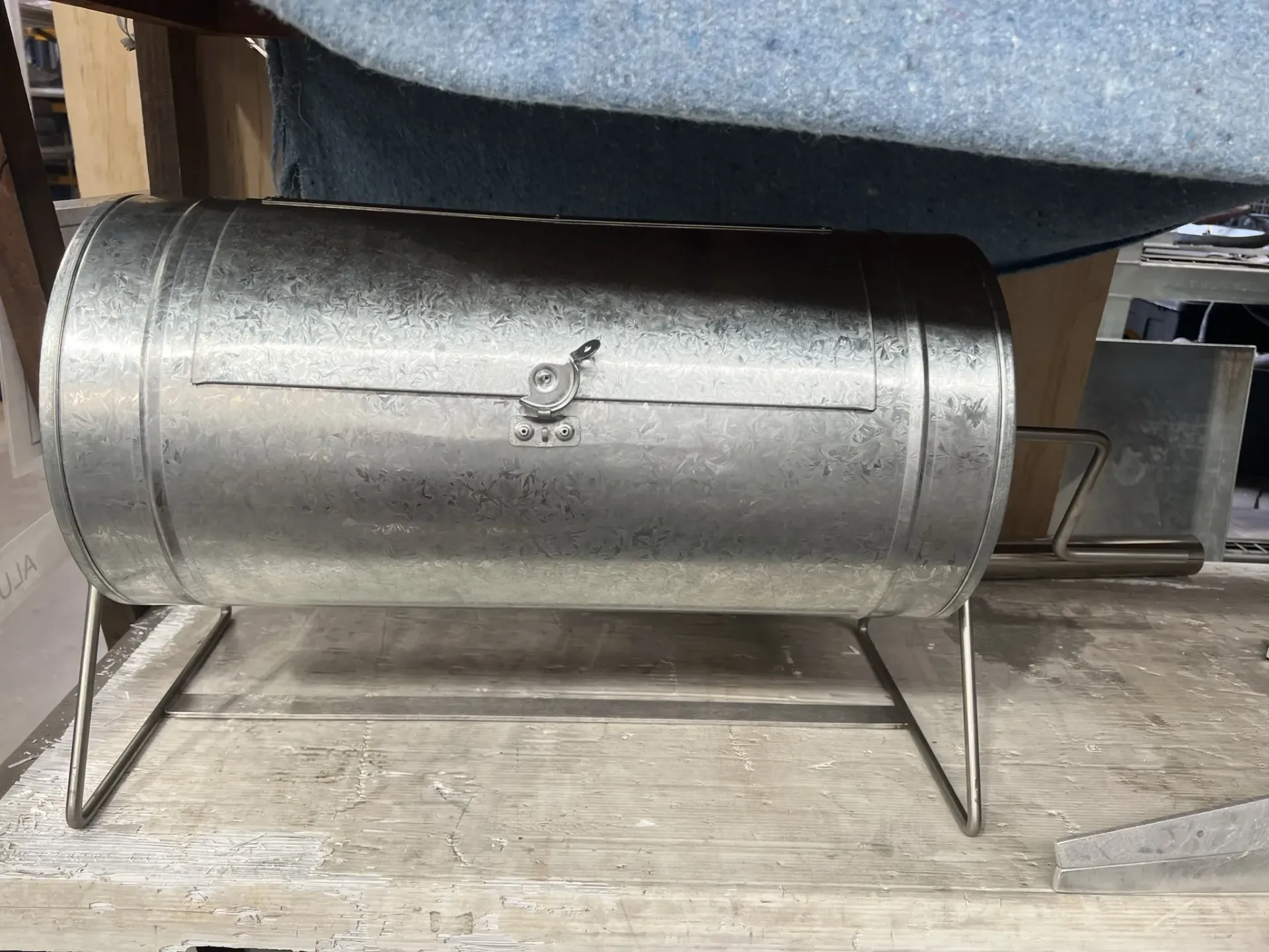 A metal barrel is sitting on a wooden table. — Keystone Engineering Sheet Metal Industries in Noosaville, QLD