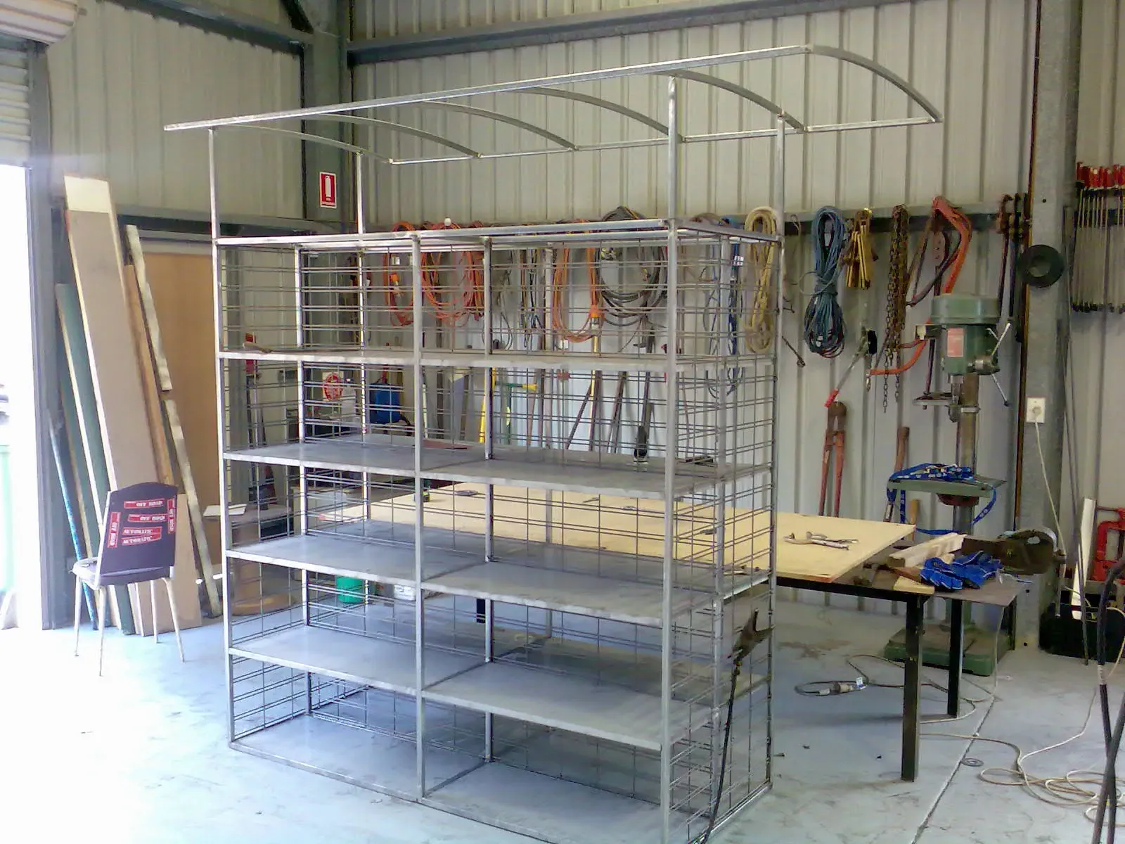 A metal shelf is sitting in a room next to a table. — Keystone Engineering Sheet Metal Industries in Noosaville, QLD