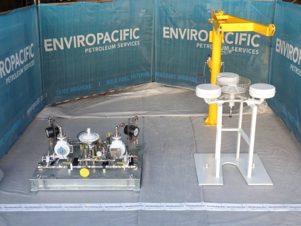 A machine is sitting in front of a fence that says enviropacific