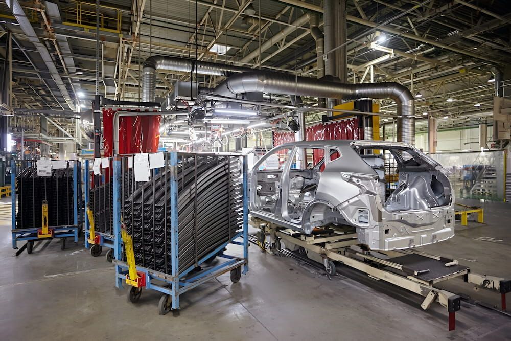 A Car Is Being Built In A Factory On A Conveyor Belt — Keystone Engineering Sheet Metal Industries in Noosaville, QLD