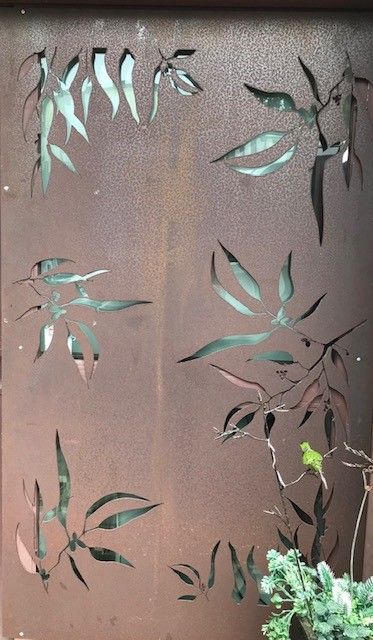 A close up of a metal wall with leaves cut out of it. — Keystone Engineering Sheet Metal Industries in Noosaville, QLD