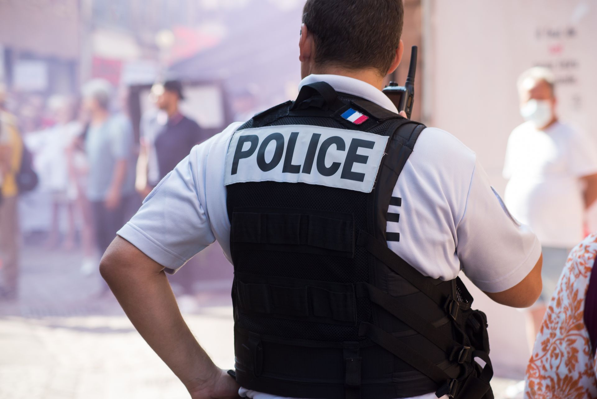 Police officer wearing a vest labeled 