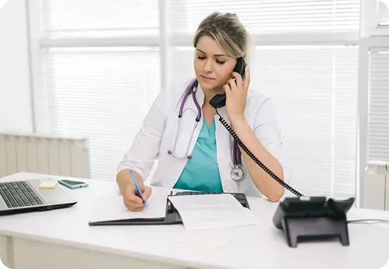 Estate agent receptionist taking calls using phone