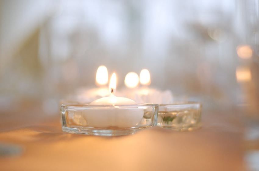 Warm candlelight on a table, helpful questions before cremation services Westminster, MD