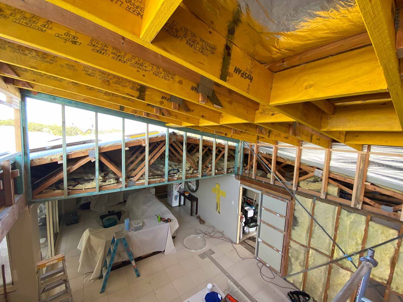 A Room Under Construction With A Wooden Ceiling And Stairs — B Smart Building & Design In Figtree, NSW
