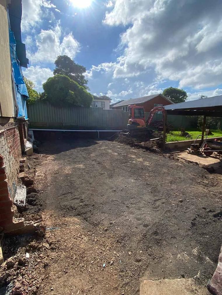 A Open Field In Front Of A House — B Smart Building & Design In Shellharbour, NSW