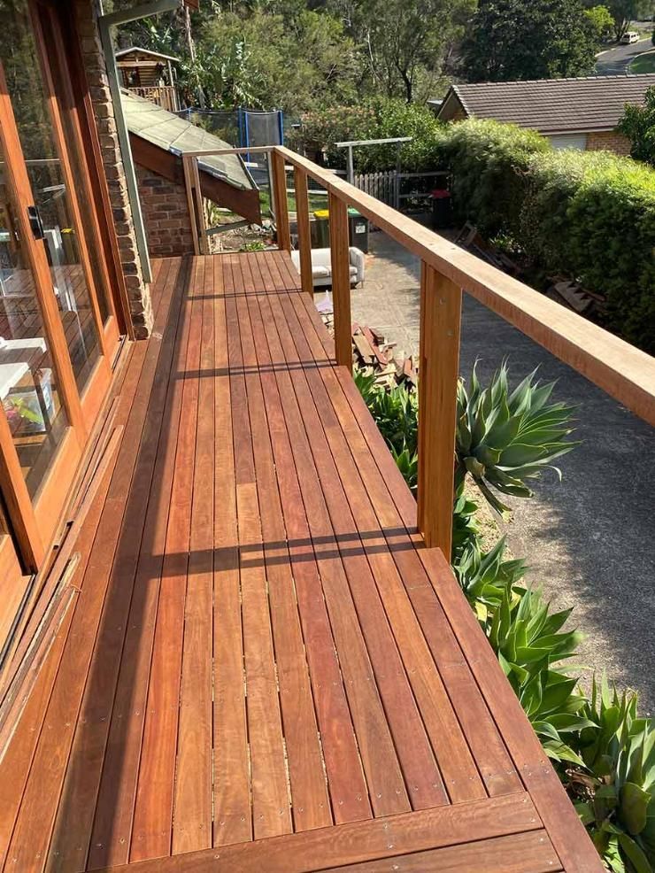 A Wooden Deck With A Railing On The Side Of A House — B Smart Building & Design In Shellharbour, NSW