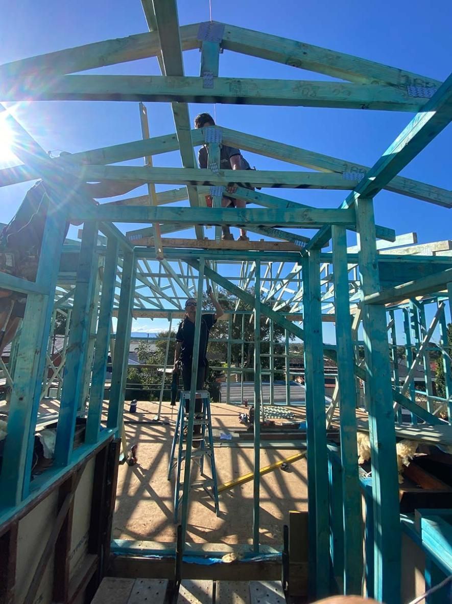A Group Of People Are Working On A Building Under Construction — B Smart Building & Design In Shellharbour, NSW