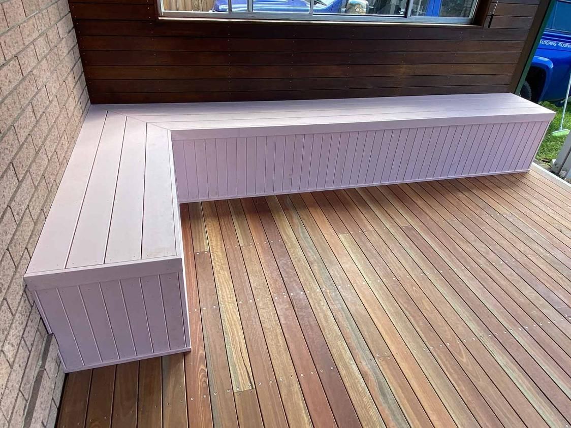 A Wooden Bench Is Sitting On A Wooden Deck Next To A Window — B Smart Building & Design In Balgownie, NSW