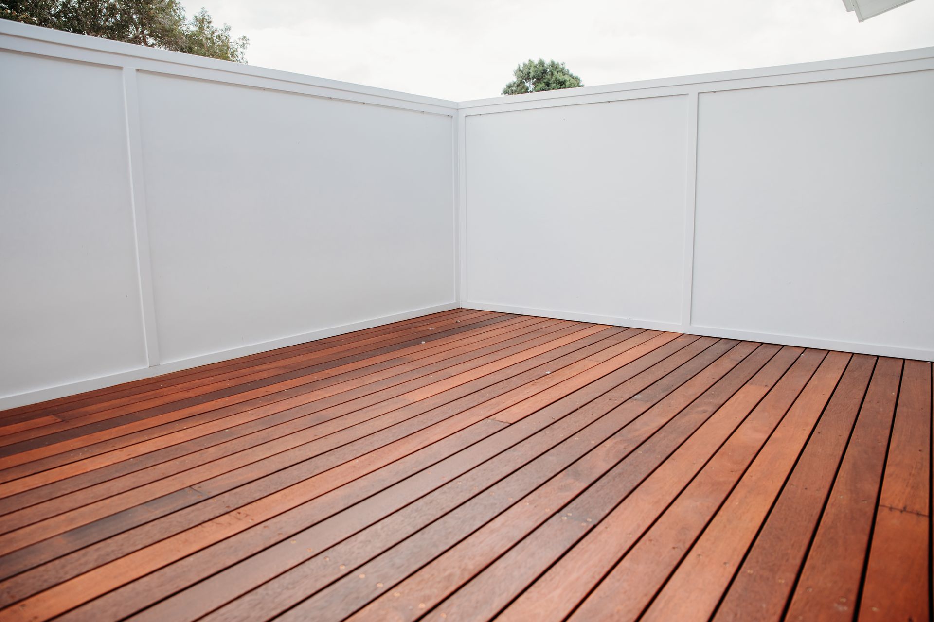 Wooden deck With A White Wall— B Smart Building & Design In Shellharbour, NSW
