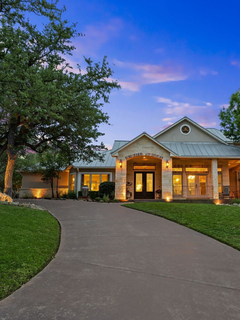 A large house with a concrete driveway leading to it